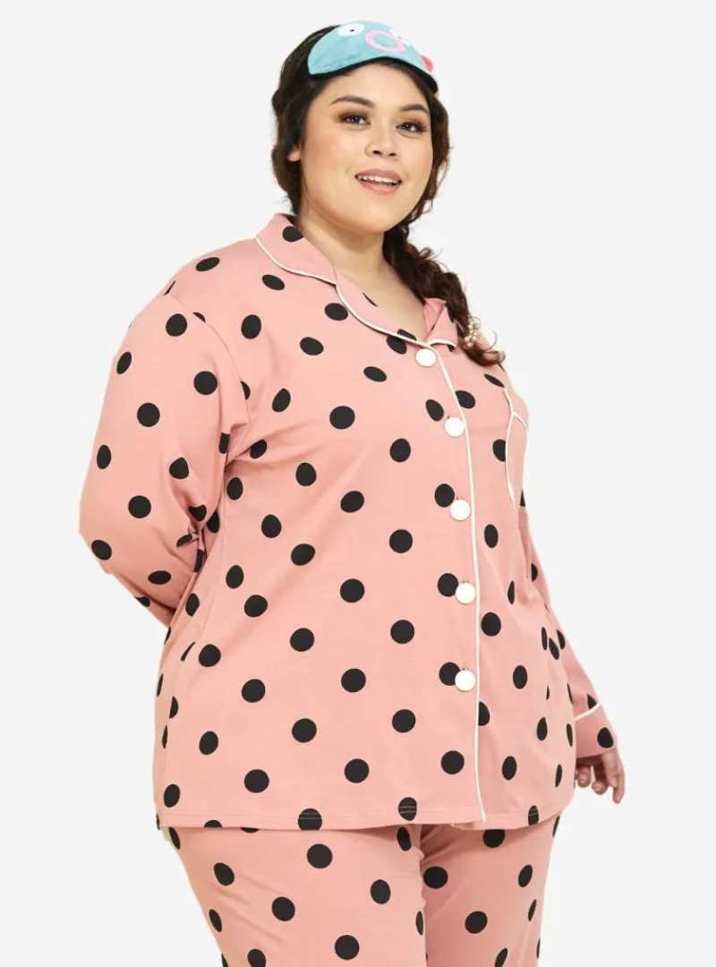 A woman dressed in Coral Polka Dotted Pyjamas