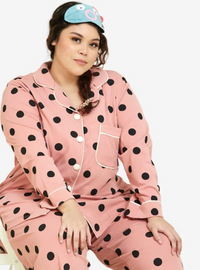 A woman dressed in Coral Polka Dotted Pyjamas