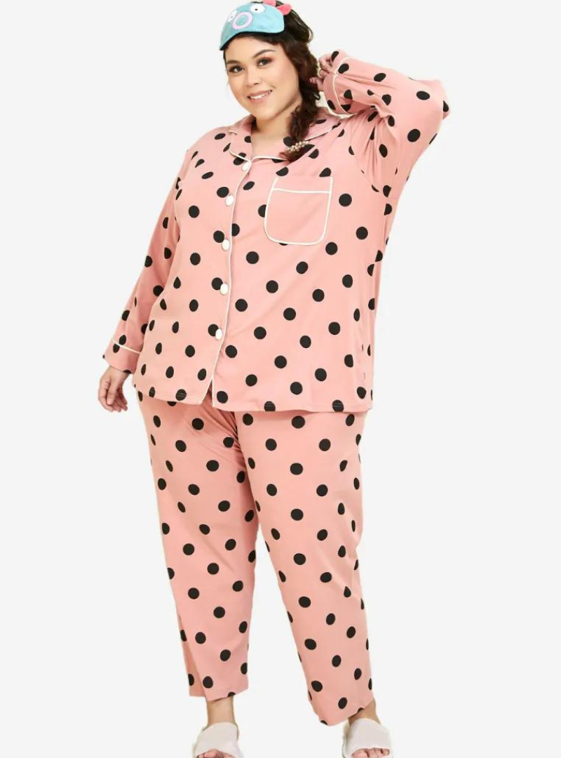 A woman dressed in Coral Polka Dotted Pyjamas