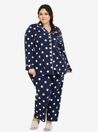 A woman dressed in Navy Polka Dotted Pyjamas