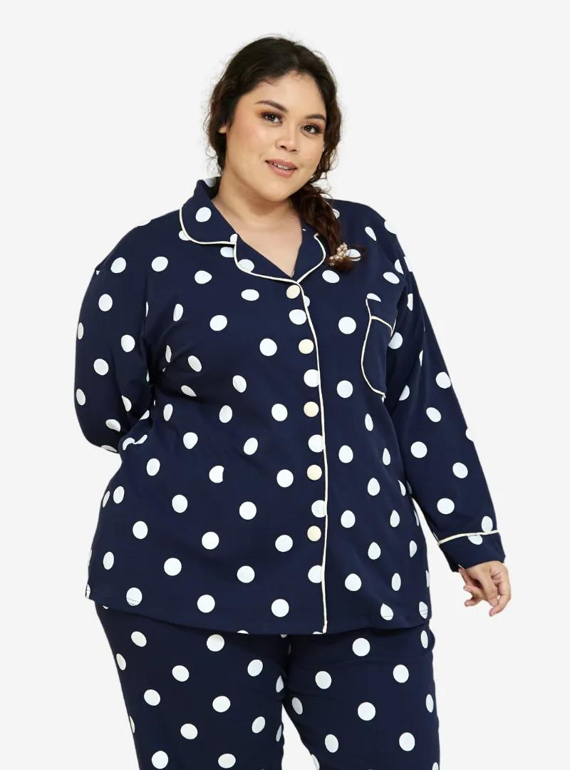 A woman dressed in Navy Polka Dotted Pyjamas