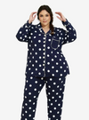 A woman dressed in Navy Polka Dotted Pyjamas