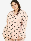 A woman dressed in Powder Pink Polka Dotted Pyjamas