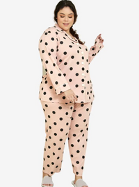 A woman dressed in Powder Pink Polka Dotted Pyjamas