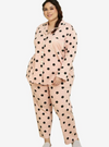 A woman dressed in Powder Pink Polka Dotted Pyjamas