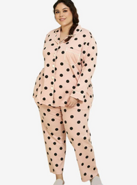 A woman dressed in Powder Pink Polka Dotted Pyjamas