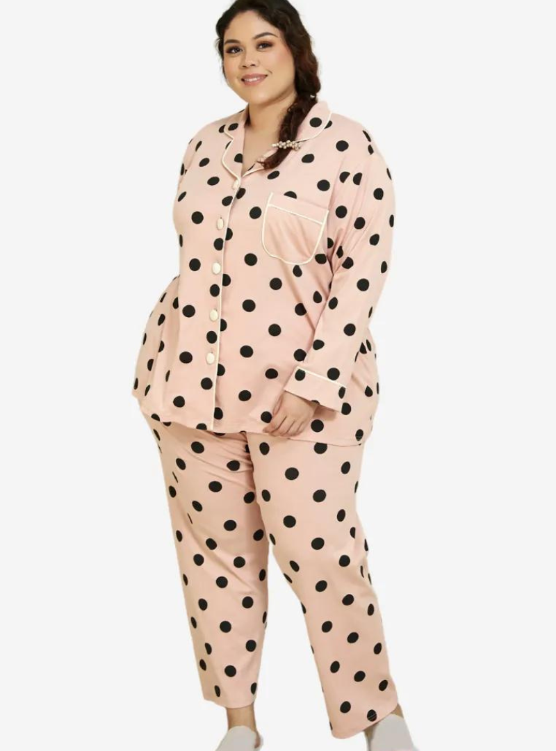 A woman dressed in Powder Pink Polka Dotted Pyjamas