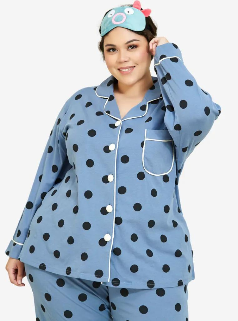 A woman dressed in Stone Blue Polka Dotted Pyjamas