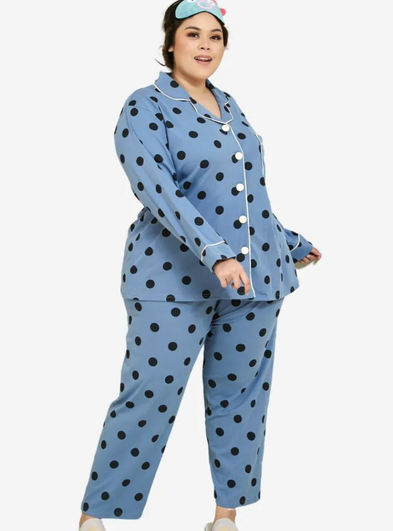 A woman dressed in Stone Blue Polka Dotted Pyjamas