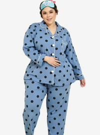 A woman dressed in Stone Blue Polka Dotted Pyjamas