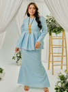 A woman dressed in Powder Blue Tun Zera Eyelet Kurung