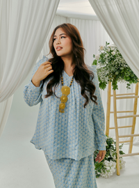 A woman dressed in Powder Blue Tun Natasha Eyelet Kurung Kedah Top