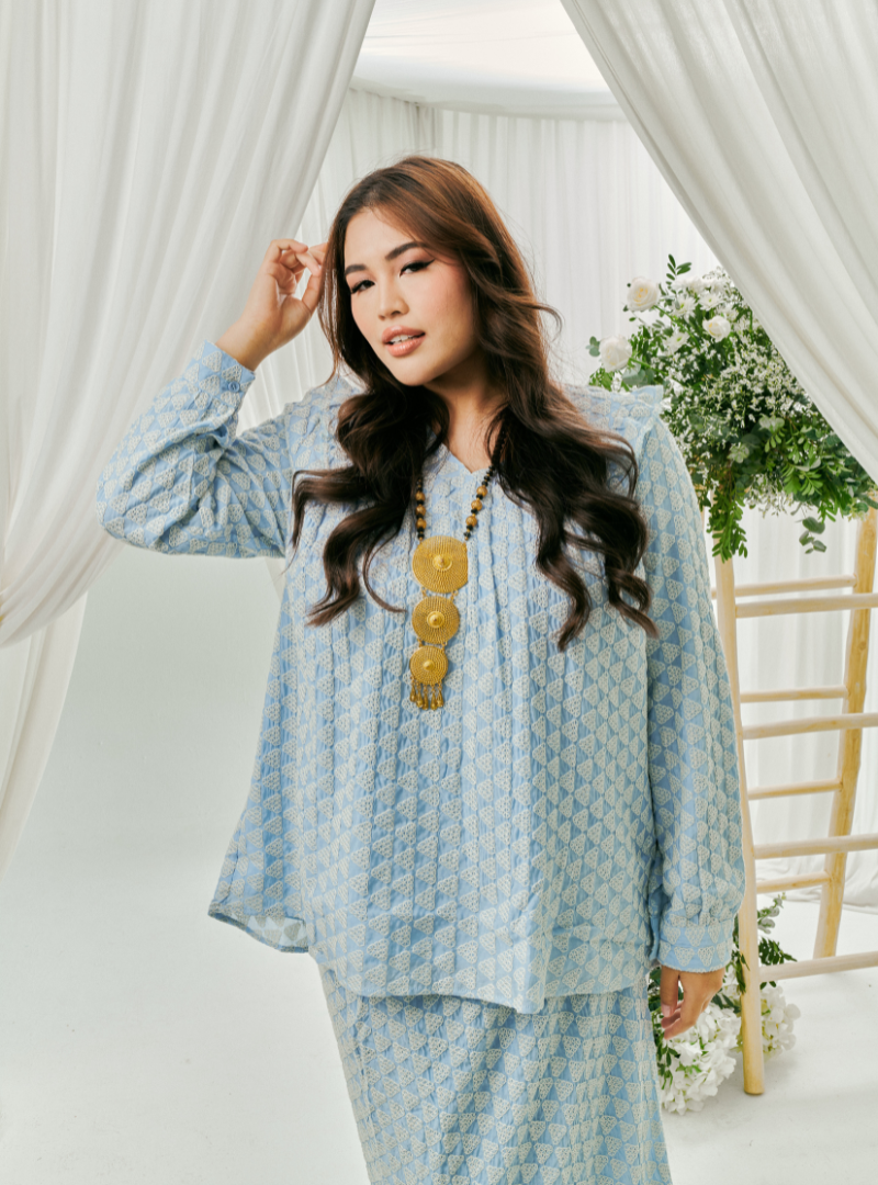 A woman dressed in Powder Blue Tun Natasha Eyelet Kurung Kedah Top