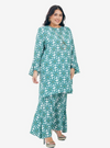 A woman dressed in Mint Daisy Premium Cotton Kurung