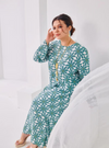 A woman dressed in Mint Daisy Premium Cotton Kurung