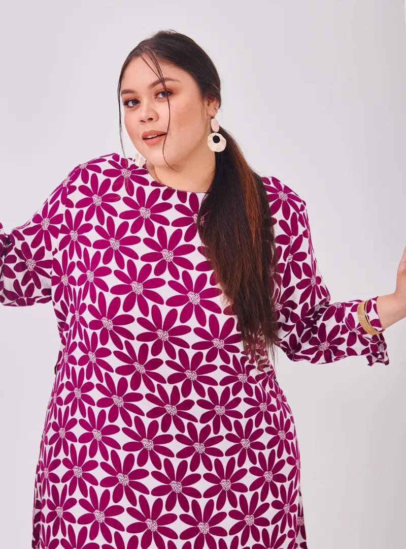 A woman dressed in Purple Daisy Premium Cotton Kurung