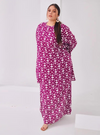 A woman dressed in Purple Daisy Premium Cotton Kurung