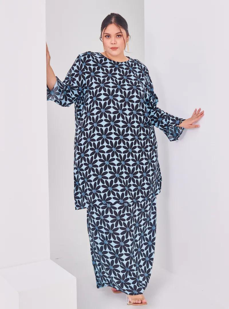 A woman dressed in Stone Blue Daisy Premium Cotton Kurung