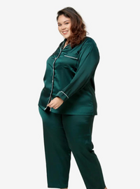 A woman dressed in Emerald Green Premium Satin Pyjamas