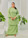 A woman dressed in Pucuk Pisang Tun Bibah Textured Kurung