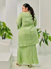 A woman dressed in Pucuk Pisang Tun Bibah Textured Kurung