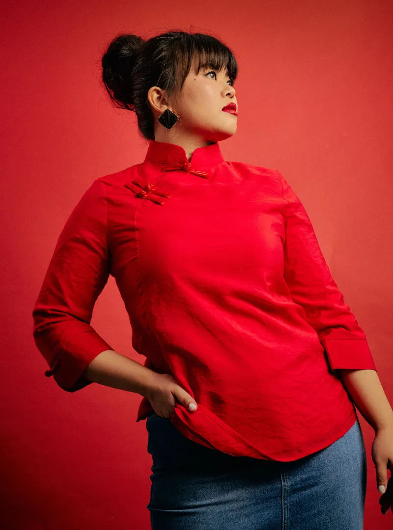 A woman dressed in Red Diva Tao Jie Cheongsam Top