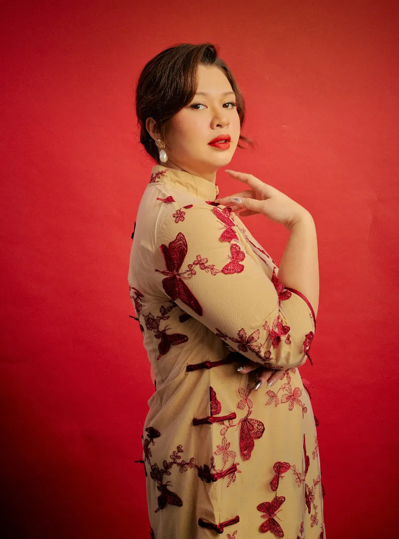 A woman dressed in Red Ying Gu Cheongsam Butterfly Lace Dress