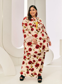 A woman dressed in Red Tun Bunga Printed Wrap Kurung