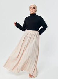 A woman wearing Rice  Basic Pleated Skirt