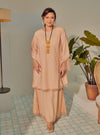 A woman dressed Rose Pink Tun Melur Dotted Kurung Pahang-