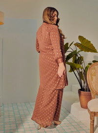 A woman dressed in Rosewood Tun Tipah Dotted Wrap Kurung