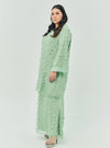 A woman dressed in Sage Green Tun Sharifah Lace Kurung