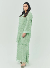 A woman dressed in Sage Green Tun Sharifah Lace Kurung