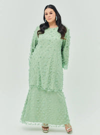 A woman dressed in Sage Green Tun Sharifah Lace Kurung