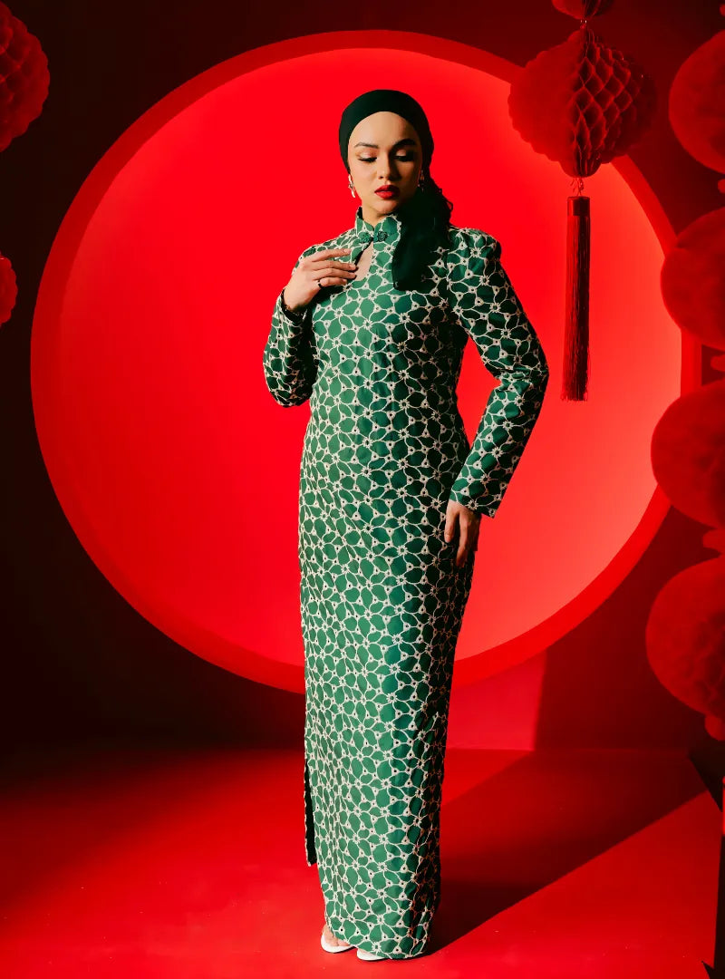 A woman dressed in Pine Green Cheongsam Eyelet