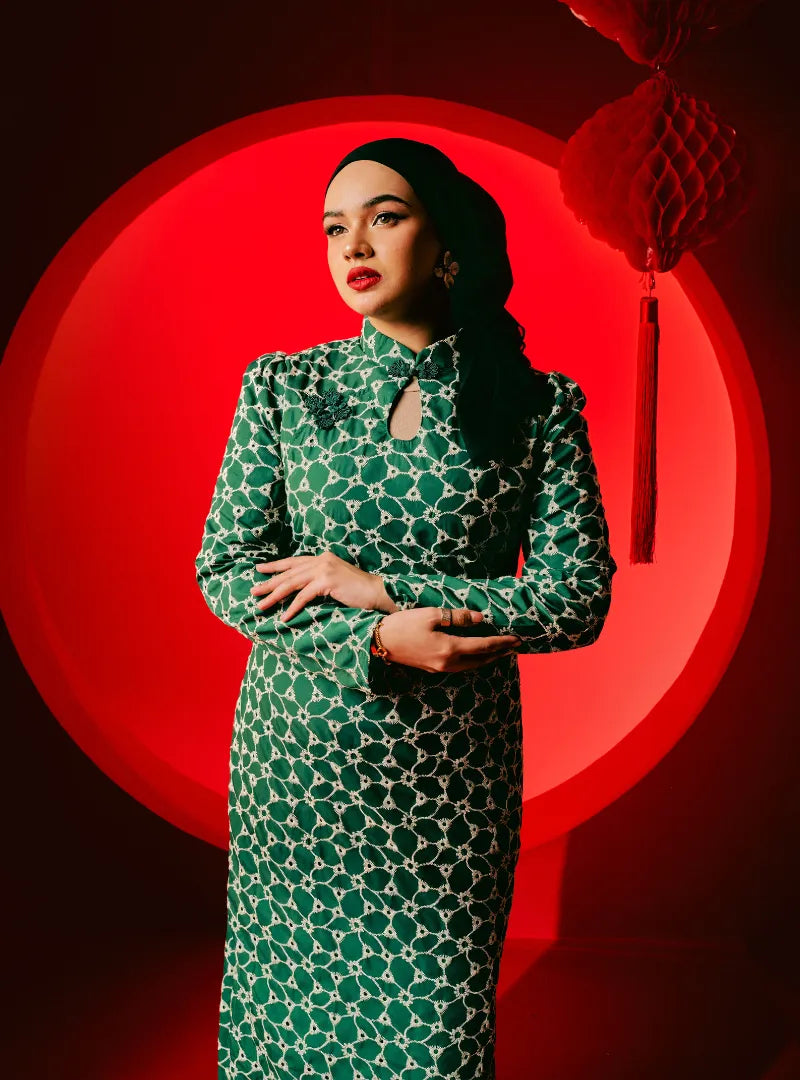 A woman dressed in Pine Green Cheongsam Eyelet