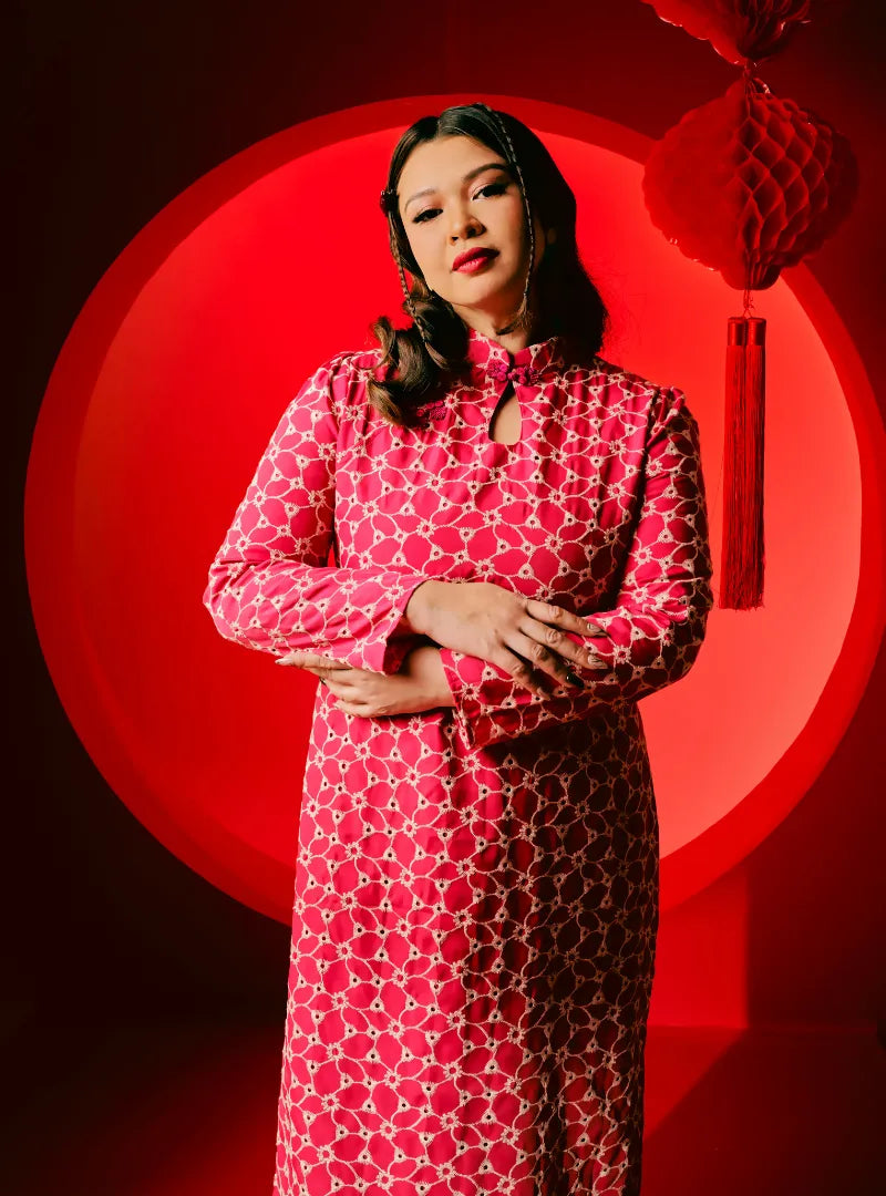 A woman dressed in Pink Doll Cheongsam Eyelet