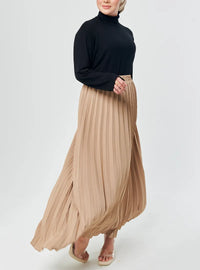 A woman wearing Sand Basic Pleated Skirt