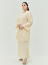 A woman dressed in Sand Tun Sharifah Lace Kurung