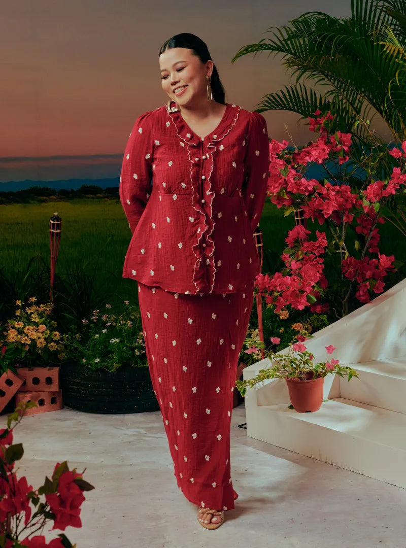  A woman dressed in Scarlet Red Tun Anisah Kebaya Kurung