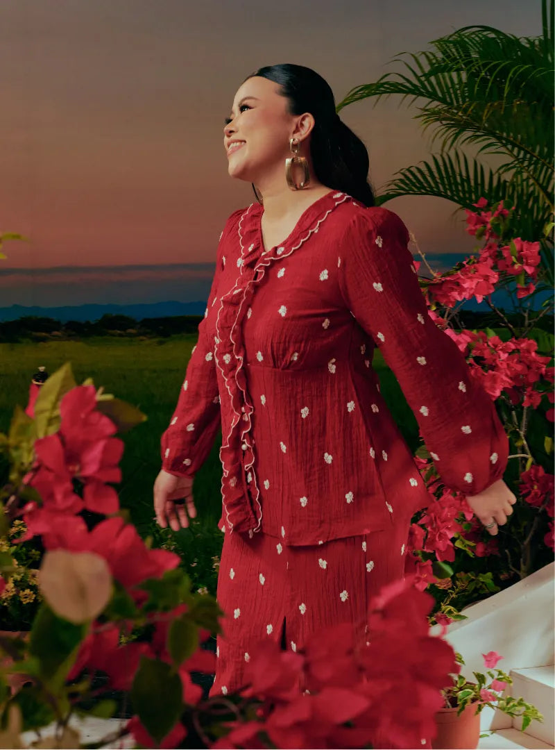  A woman dressed in Scarlet Red Tun Anisah Kebaya Kurung