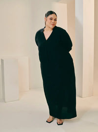 A woman dressed in Black Selsae Mandarin Collar Kaftan