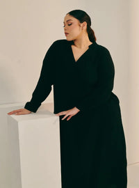 A woman dressed in Black Selsae Mandarin Collar Kaftan