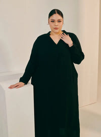 A woman dressed in Black Selsae Mandarin Collar Kaftan