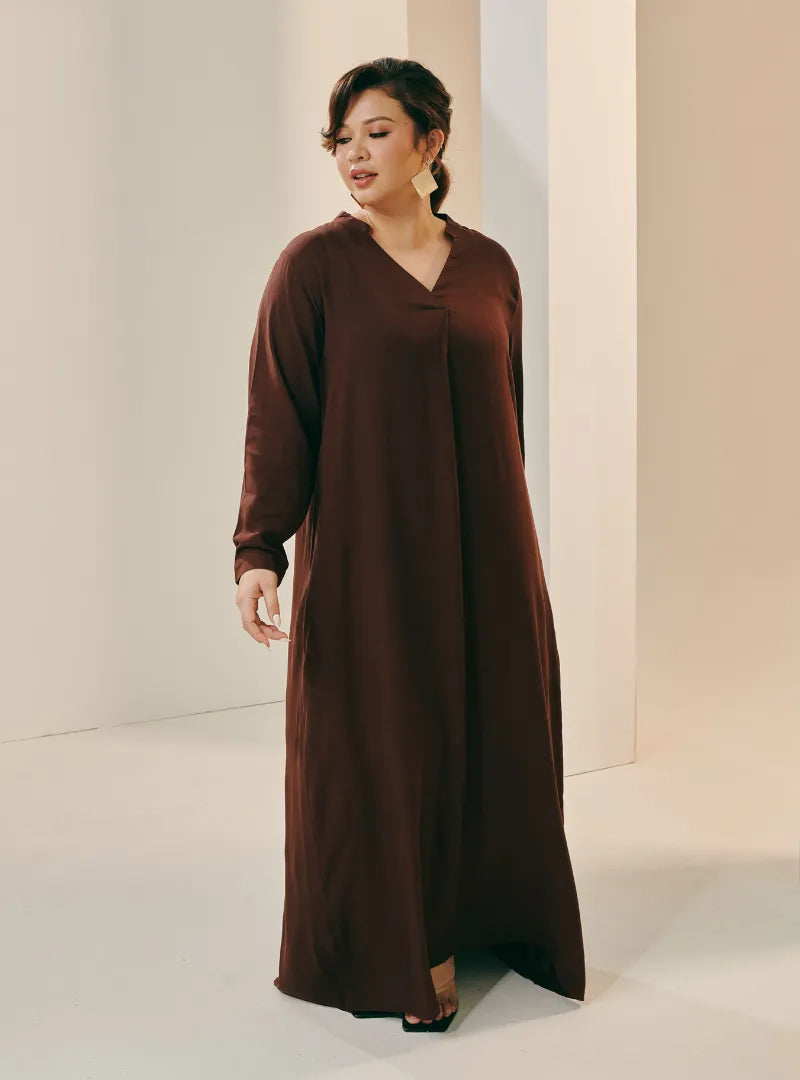 A woman dressed in Dark Coco Selsae Mandarin Collar Kaftan