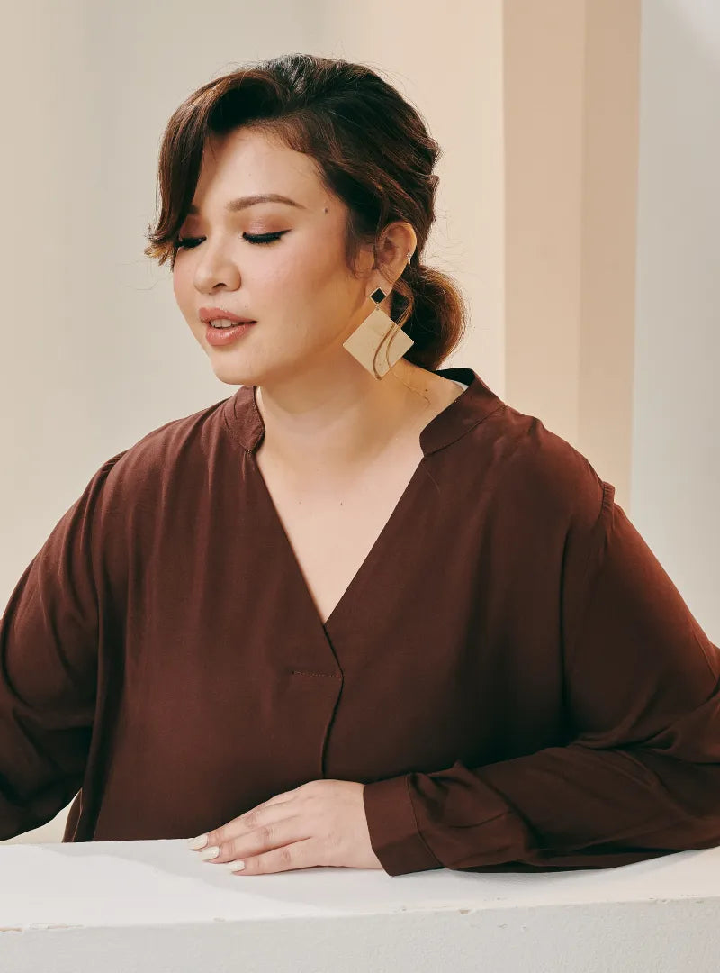 A woman dressed in Dark Coco Selsae Mandarin Collar Kaftan