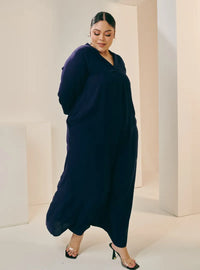 A woman dressed in Navy Selsae Mandarin Collar Kaftan