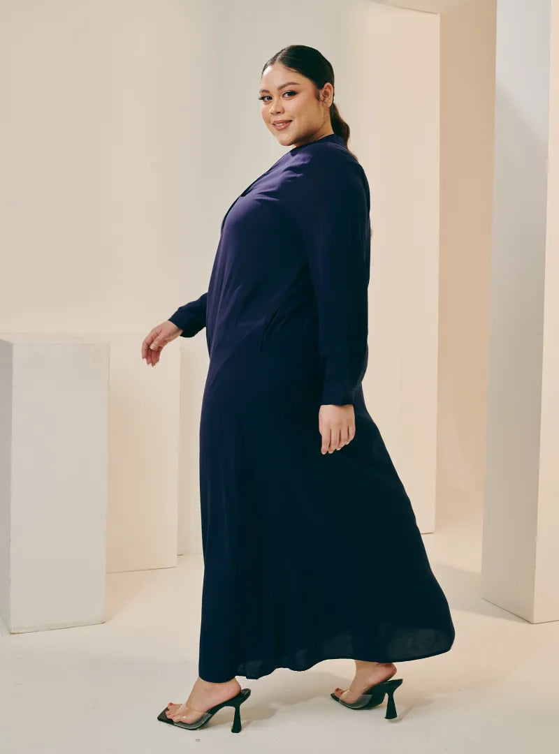 A woman dressed in Navy Selsae Mandarin Collar Kaftan