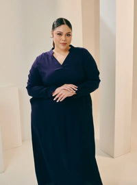 A woman dressed in Navy Selsae Mandarin Collar Kaftan