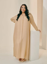 A woman dressed in Sand Selsae Mandarin Collar Kaftan